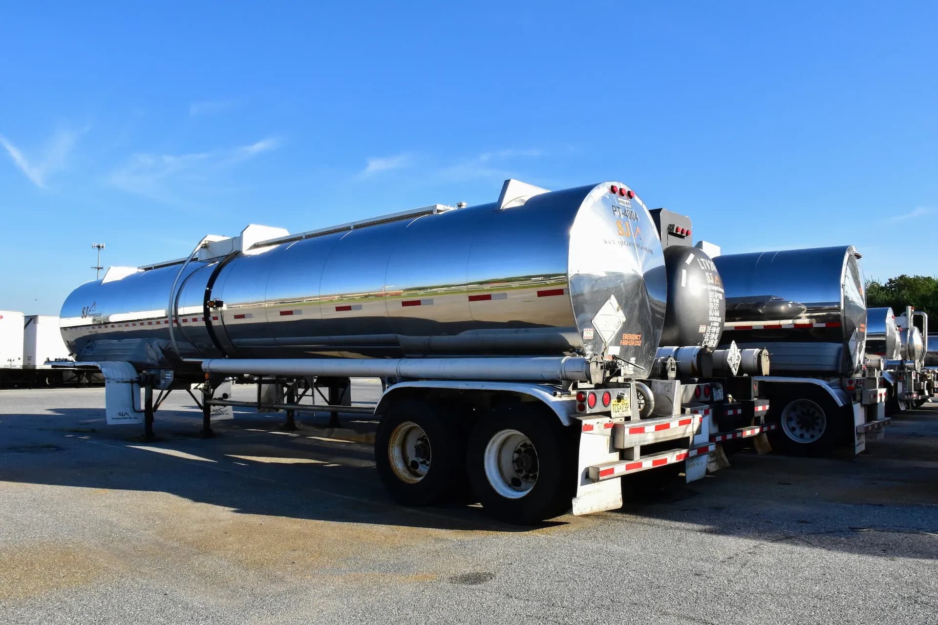 a parked oil tanker with mirror finish reflecting its environment